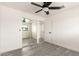 Bright bedroom featuring gray floors, a ceiling fan, and mirrored closet doors at 3044 W Dahlia Dr, Phoenix, AZ 85029