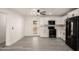 Bright kitchen features stainless appliances, white cabinetry and grey toned wood flooring at 3044 W Dahlia Dr, Phoenix, AZ 85029