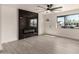 Modern living room featuring a stylish electric fireplace and bright natural light from the window at 3044 W Dahlia Dr, Phoenix, AZ 85029