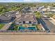 Distant daytime aerial view of a home showcasing a pool, a covered patio and backyard landscaping at 3125 W Desert Ln, Laveen, AZ 85339