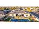 Wide aerial view of the house showing the backyard pool, patio area, and neat landscaping at 3125 W Desert Ln, Laveen, AZ 85339