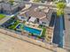 Daytime aerial view of a home showcasing a pool, a covered patio and backyard landscaping at 3125 W Desert Ln, Laveen, AZ 85339