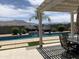 Entertainer's backyard featuring a sparkling pool, covered patio, and serene mountain views create an ideal setting at 3125 W Desert Ln, Laveen, AZ 85339