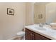 Powder room showcases a modern vanity with sink and fixtures, and tile flooring at 3125 W Desert Ln, Laveen, AZ 85339