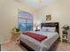 Comfortable bedroom with a large window, ceiling fan, and neutral decor at 3125 W Desert Ln, Laveen, AZ 85339