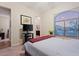 Well-lit bedroom with neutral walls, carpet, and large window at 3125 W Desert Ln, Laveen, AZ 85339