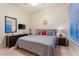 Well-lit bedroom features a ceiling fan, window and neutral-toned walls and carpet flooring at 3125 W Desert Ln, Laveen, AZ 85339