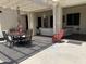 Spacious covered patio with comfortable seating creates an ideal outdoor living space for dining and relaxation at 3125 W Desert Ln, Laveen, AZ 85339
