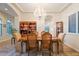 Inviting dining room featuring a stunning chandelier and seamless flow into adjacent spaces at 3125 W Desert Ln, Laveen, AZ 85339