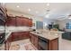 Open kitchen boasts dark wood cabinetry, granite countertops, and stainless steel appliances at 3125 W Desert Ln, Laveen, AZ 85339