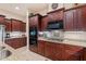 Spacious kitchen features granite counters, stainless appliances, and dark wood cabinetry at 3125 W Desert Ln, Laveen, AZ 85339