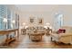 Formal living room with wood floors, elegant furnishings, and ample natural light at 3125 W Desert Ln, Laveen, AZ 85339