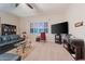 Comfortable living room features plush seating, a large window, and neutral carpet flooring at 3125 W Desert Ln, Laveen, AZ 85339