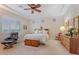 Spacious main bedroom with a tray ceiling, large windows and a comfortable seating area at 3125 W Desert Ln, Laveen, AZ 85339