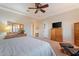 Comfortable main bedroom with a ceiling fan, natural light and traditional furnishings at 3125 W Desert Ln, Laveen, AZ 85339
