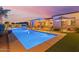 Backyard oasis with a sleek pool, landscaping, and inviting patio area, perfect for relaxation at 3125 W Desert Ln, Laveen, AZ 85339