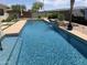 Inviting pool featuring a waterfall and lush landscaping offers a serene and private backyard oasis at 3125 W Desert Ln, Laveen, AZ 85339
