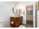 Bathroom vanity featuring a rounded mirror, marble counter and wood laminate flooring at 318 E Taylor Trl, San Tan Valley, AZ 85143