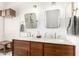Bright bathroom featuring double sink vanity with marble countertop and unique square mirrors at 318 E Taylor Trl, San Tan Valley, AZ 85143