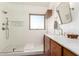 Bathroom featuring a walk-in shower with white tiling, a modern vanity, and a bright window at 318 E Taylor Trl, San Tan Valley, AZ 85143