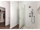 Bathroom showcasing a frameless glass shower, white subway tiles, and well-organized closet space at 318 E Taylor Trl, San Tan Valley, AZ 85143