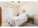 Bright bedroom features a metal bed frame, curtains, and complementary bedside table at 318 E Taylor Trl, San Tan Valley, AZ 85143