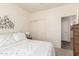 Comfortable bedroom featuring a white metal frame bed and an adjacent door to another room at 318 E Taylor Trl, San Tan Valley, AZ 85143