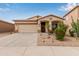 Charming single-story home with a two-car garage, desert landscaping, and a sun-inspired architectural detail at 318 E Taylor Trl, San Tan Valley, AZ 85143