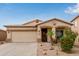 Charming single-story home with a well-manicured yard, desert landscaping, and a two-car garage at 318 E Taylor Trl, San Tan Valley, AZ 85143