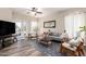 Inviting living room featuring modern furniture, wood floors, and view to outside pool at 318 E Taylor Trl, San Tan Valley, AZ 85143
