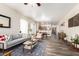 Open-concept living room features a modern couch, stylish decor, and seamless flow to the dining area at 318 E Taylor Trl, San Tan Valley, AZ 85143