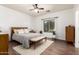 Bright main bedroom with a ceiling fan, natural light, and minimalist furniture at 318 E Taylor Trl, San Tan Valley, AZ 85143