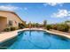 A refreshing backyard pool area surrounded by lush greenery, providing a private oasis for relaxation and enjoyment at 318 E Taylor Trl, San Tan Valley, AZ 85143