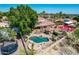 Spacious backyard offers a refreshing pool and play area at 3413 E Equestrian Trl, Phoenix, AZ 85044