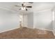Bedroom with plush carpet, neutral paint, and a door leading to a walk-in closet at 3413 E Equestrian Trl, Phoenix, AZ 85044