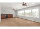 Upstairs bonus room including a wet bar, beverage fridge, and large windows at 3413 E Equestrian Trl, Phoenix, AZ 85044