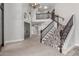 Spacious foyer with staircase, designer carpet, and elegant lighting with custom doors at 3413 E Equestrian Trl, Phoenix, AZ 85044