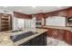 Modern kitchen featuring granite countertops, stainless steel appliances, and custom wood cabinetry at 3413 E Equestrian Trl, Phoenix, AZ 85044