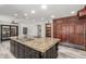 Spacious kitchen with large island, granite countertops, custom cabinets, and modern stainless steel appliances at 3413 E Equestrian Trl, Phoenix, AZ 85044