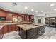 Luxury kitchen featuring a large island, granite countertops, and abundant custom wood cabinets at 3413 E Equestrian Trl, Phoenix, AZ 85044