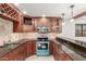 Inviting kitchen showcasing custom cabinetry, granite countertops, and modern stainless steel appliances at 3413 E Equestrian Trl, Phoenix, AZ 85044