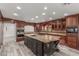 Gourmet kitchen featuring a large island with granite countertops, custom cabinetry, and stainless steel appliances at 3413 E Equestrian Trl, Phoenix, AZ 85044