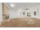 Expansive living room with a stone fireplace and ceiling fan at 3413 E Equestrian Trl, Phoenix, AZ 85044