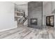 Open-concept living room features a modern fireplace, staircase and ample natural light at 3413 E Equestrian Trl, Phoenix, AZ 85044
