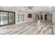Open-concept living room with wood-look flooring, archways, recessed lighting, and sliding glass doors at 3413 E Equestrian Trl, Phoenix, AZ 85044