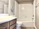 Traditional bathroom featuring a white tiled shower-tub combo and wooden vanity at 3420 W Danbury Dr # C130, Phoenix, AZ 85053