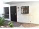Charming entryway with a black door and decorative window at 3420 W Danbury Dr # C130, Phoenix, AZ 85053