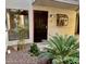 Close up of a building's exterior, featuring a dark front door, a decorative window, and manicured landscaping at 3420 W Danbury Dr # C130, Phoenix, AZ 85053