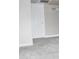 A hallway with neutral carpet and light-colored walls, leading to a room with a white door at 3420 W Danbury Dr # C130, Phoenix, AZ 85053