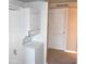 The laundry area features a stacked washer and dryer next to a white door at 3420 W Danbury Dr # C130, Phoenix, AZ 85053